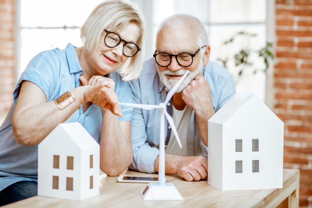 Residential Clearn Energy Credit. Senior couple viewing a wind turbine model.