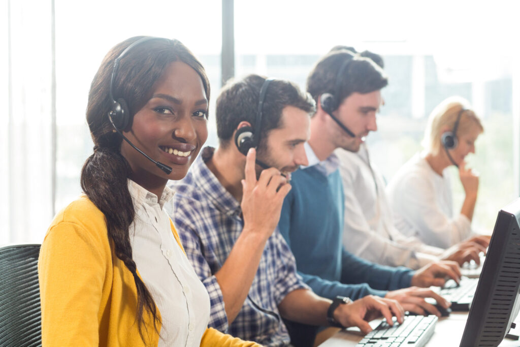 Dedicated customer service team working collaboratively at their desks, providing professional support and assistance to clients. A focused and engaged group ensuring exceptional service delivery